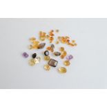A collection of loose quartz gemstones, including citrine, smoky quartz, amethyst, 60ct