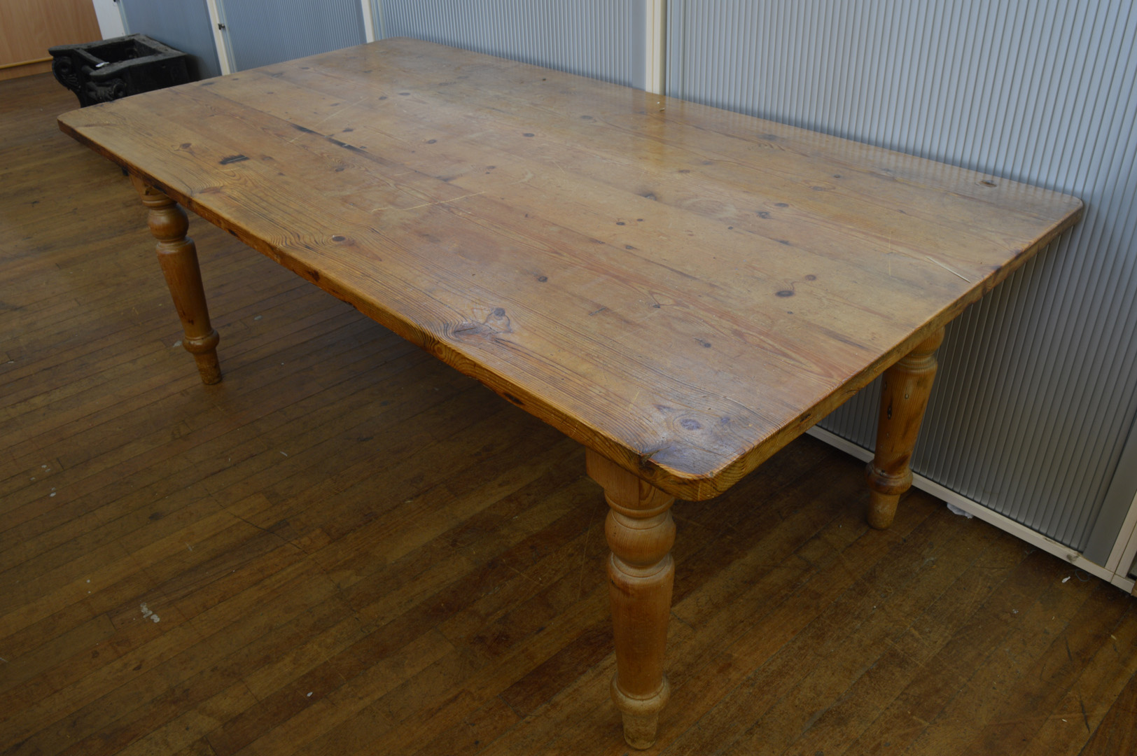 An early 20th Century pine kitchen table, of rectangular form, turned supports, 187cm x 101cm x 73cm