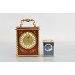 A continental hand painted and brass mantel clock, with circular brass dial and white enamel roman