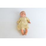 An Armand Marseille baby doll, with blue sleeping eyes, open mouth, composition body, some