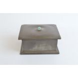 A Liberty Tudric pewter casket, wooden lined, the domed lid centred with turquoise matrix, stamped