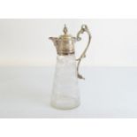 An Edwardian silver plated claret jug, the silver collar with mask head spout, scroll dragon