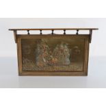 A 1900s oak framed copper embossed plaque, depicting British warships in battle off coastal