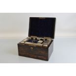 A 19th Century coromandel gentleman's dressing table box, with silver lidded contents hallmarked