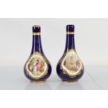 A near pair of Staffordshire porcelain bottle vases and covers, having hand painted panels, on