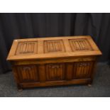 An oak linen fold coffer, reproduction in manufacture, 100cm wide x 44cm deep x 54cm high