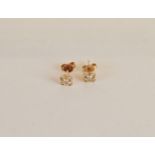 A pair of 14ct gold and diamond cruciform ear studs, the brilliant cuts in sunken centres all in