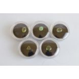 Five green gemstones, comprising an oval polished cabochon jade, 1.5ct, oval mixed cut apatite, 2.