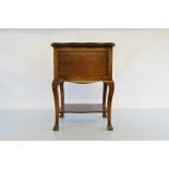 A 1900s stained beech sewing box table, with swivel top revealing fitted interior on shaped legs