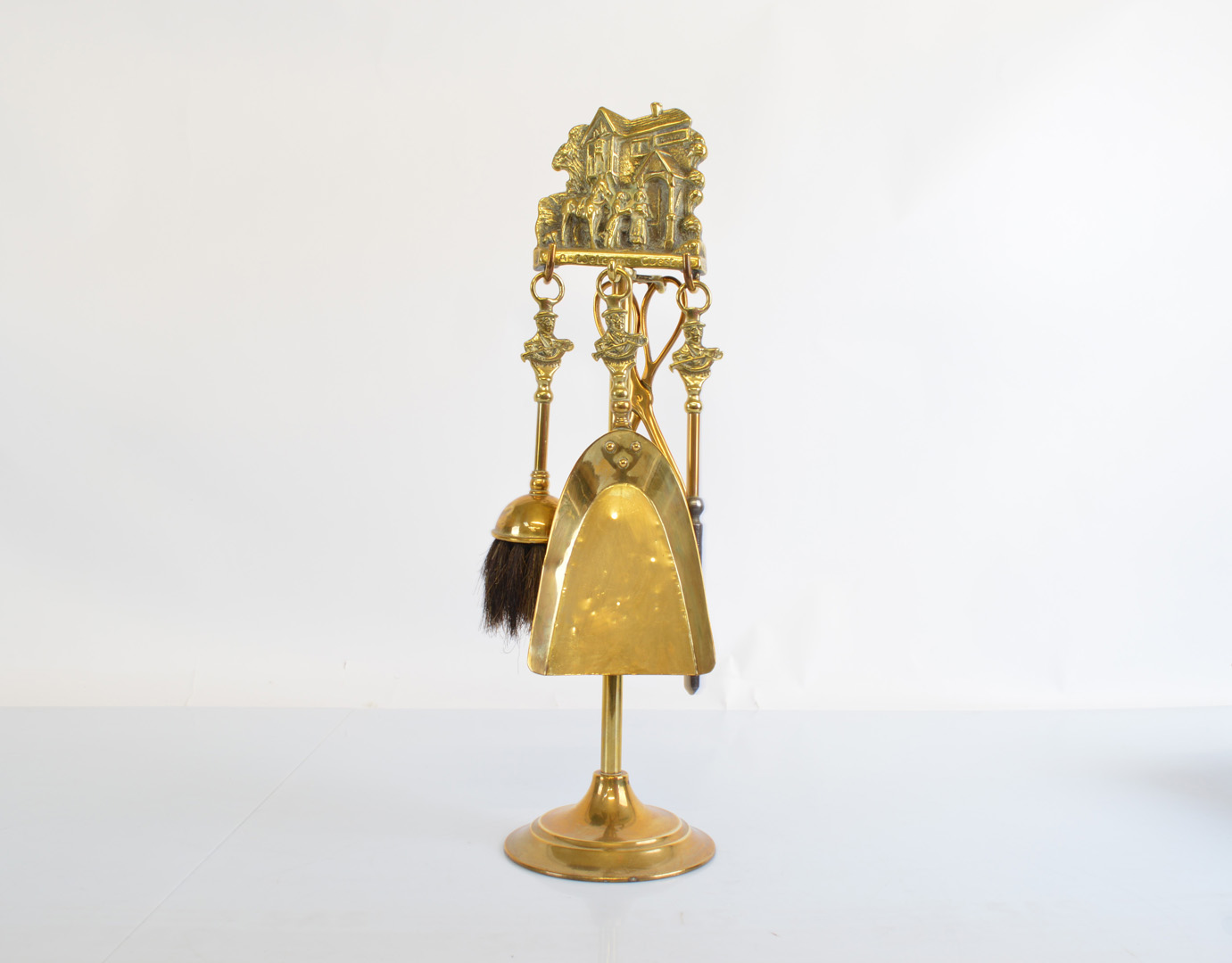 A brass fire companion set, titled A Welcome Guest with John Peel handle accoutrements, 47cm high