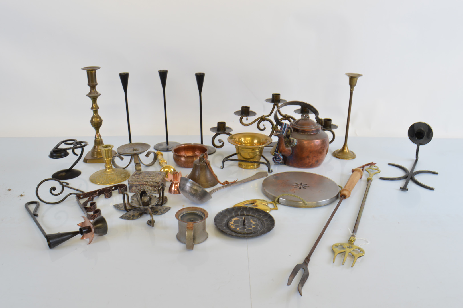 A collection of brass and copper ware, mostly Norwegian in origin including a pestle and mortar, a