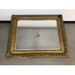 A modern and large gilt wall mirror, 135cm by 110cm, one corner loose (2)