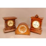 A group of three mantle clocks, comprising two 14 day striking German clocks, in mahogany and oak