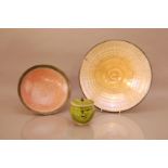 Three items of studio pottery, comprising a large Raku bowl by John Dunn, 34cm diameter, a small