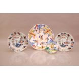 A pair of 19th century polychrome Delft plates, AF, together a larger restored charger,. 31cm, and a