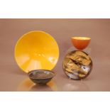 Four items of studio pottery, comprising a large bright yellow dish by George Wilson, 28cm diameter,