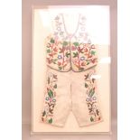 A Vintage Native American child's outfit, the calf hide shorts and waistcoat having intricately