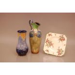 Three ceramic items of Royal Doulton, including two vases, one with a broken and repaired handle