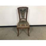 An Art Nouveau carved single chair in the style of Vander Velde, AF, with Liberty style material