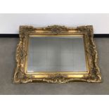 A modern and heavy gilt wall mirror, in the Louis XVI style, 122cm by 92cm