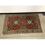 An early 20th century Middle Eastern woollen carpet, AF, 175cm by 110cm