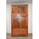 A large Far Eastern Cabinet, having to large doors, opening to reveal internal a lower blanket