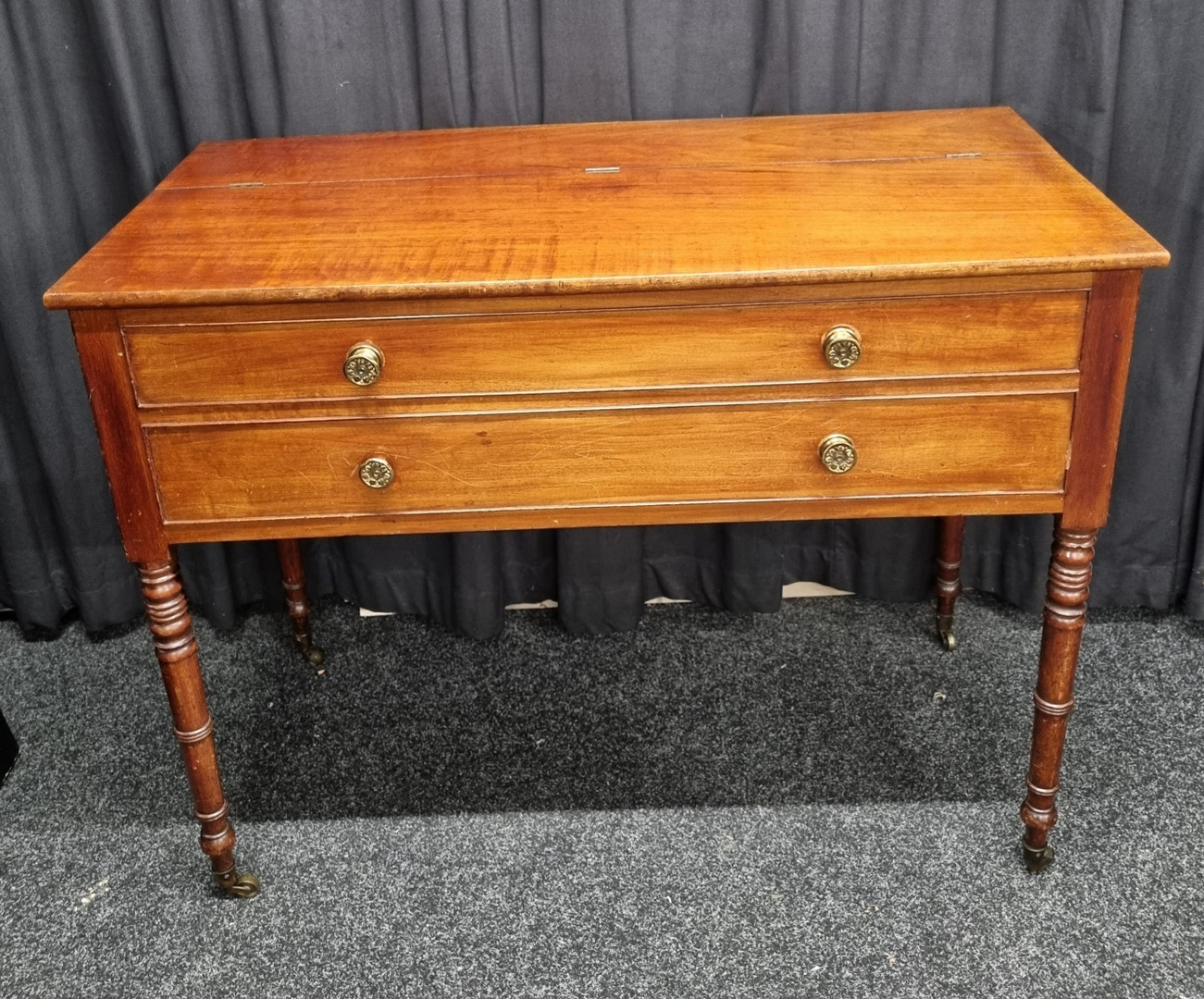 An 1840 mahogany piano forte converted to side table, with lifting lid and faux drawers with brass