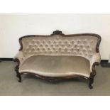 A late 19th century carved walnut framed settee, 176cm, with later beige velvet upholstery, faded to
