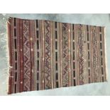 A mid 20th century Middle Eastern Kilim flat weave carpet, 203cm long and 127cm wide, faded