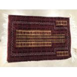 A 20th century Middle Eastern Mihrab, the woollen prayer mat 142cm long and 97cm wide