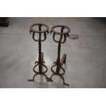 A pair of French mid-20th century wrought iron fire irons and another pair of fire dogs, having