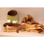 A collection of fur items, including a mink hat retailed by Harrods in its original retail box,