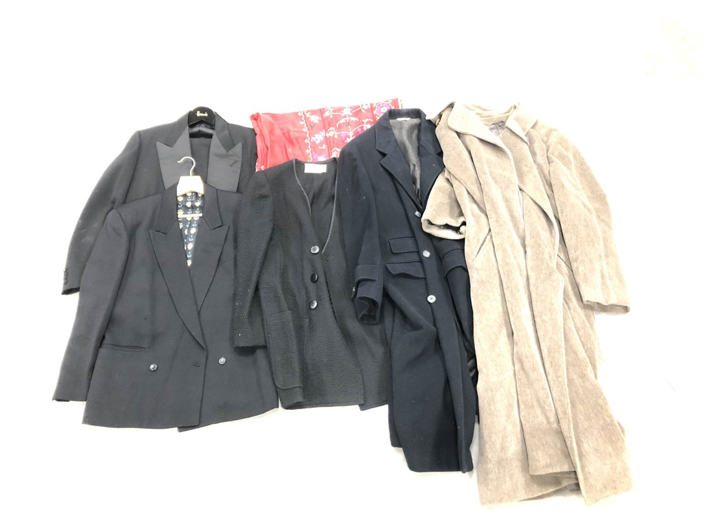 A collection of men's and woman's clothes, including a dinner jacket and trousers, double breasted