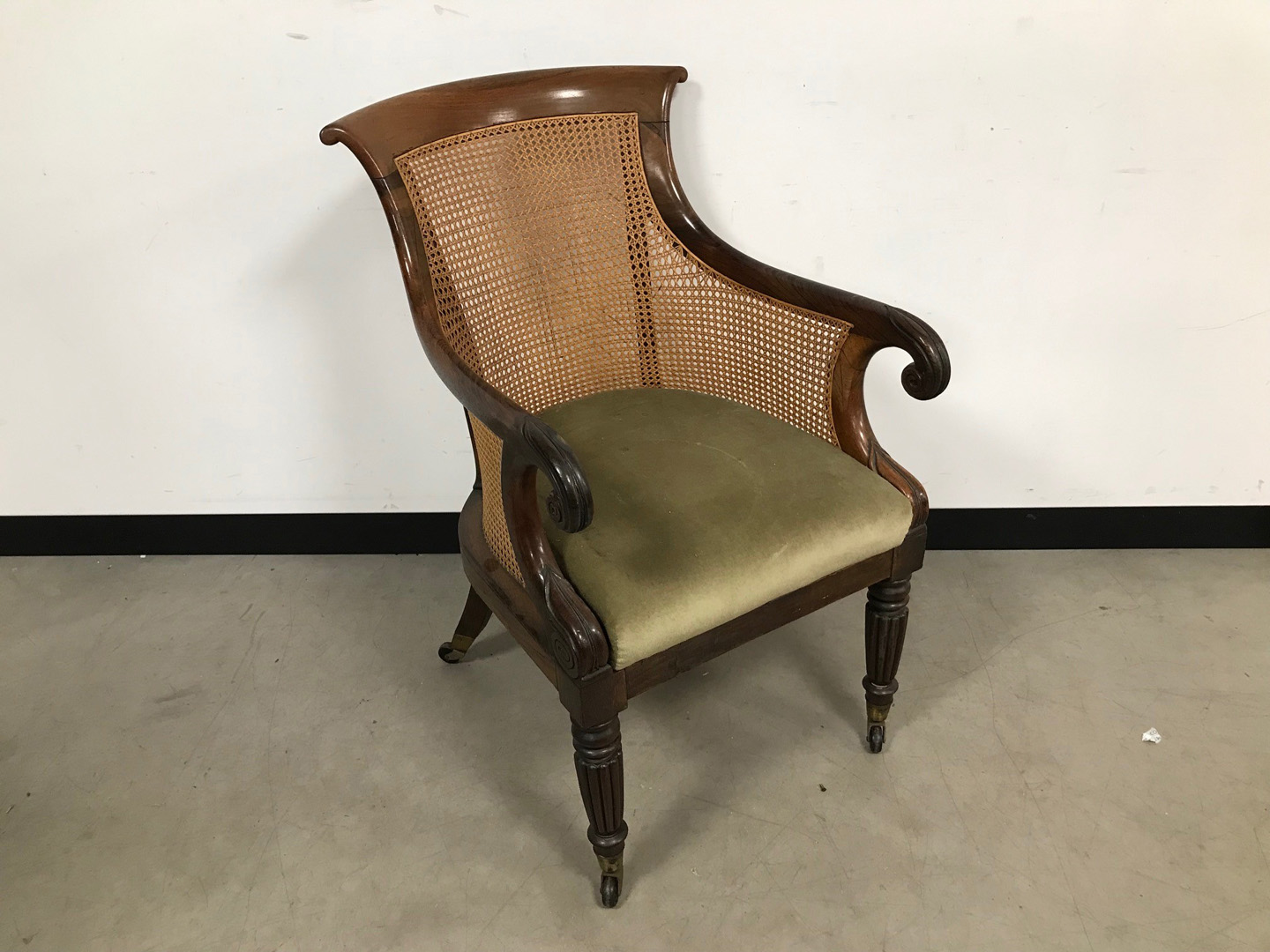 A Regency period rosewood and cane armchair, wit padded seat