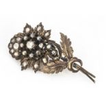 A 19th century silver set diamond and gold floral brooch, the rose cut diamonds in a flower head