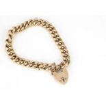 A 15ct gold padlock clasped curbed linked bracelet, the links united with a padlock and safety