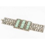 A Chinese jadeite jade and silver gilt three panel bracelet, each rectangular panel carved with a