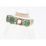 A 18ct marked emerald and diamond dress ring, mixed oval cut emeralds, alternately set with pair