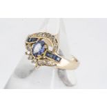 A continental yellow metal sapphire and diamond ring, a cluster cross over design, central claw