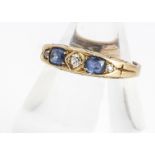 An 18 marked five stone sapphire and diamond dress ring, two oval mixed cuts, alternately set with