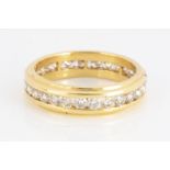 A continental yellow metal full eternity ring, brilliant cuts channel set, moulded and stepped