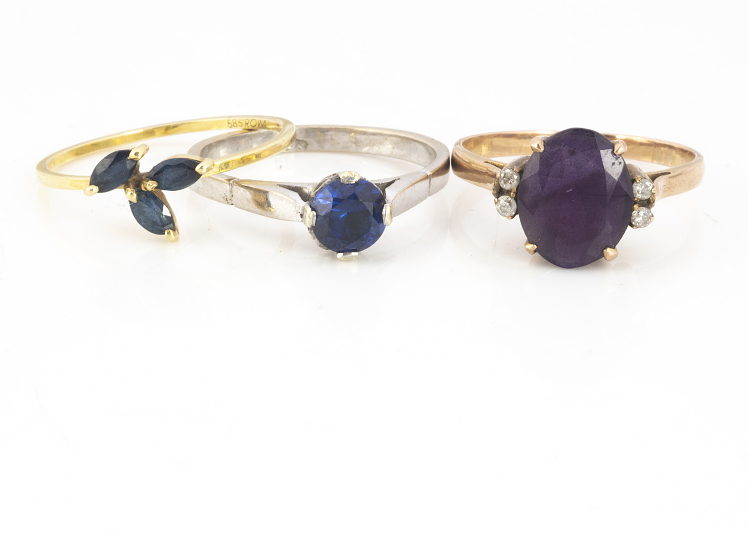 An Amethyst and diamond dress ring, in yellow metal, ring size N, together with a three stone