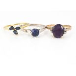 An Amethyst and diamond dress ring, in yellow metal, ring size N, together with a three stone