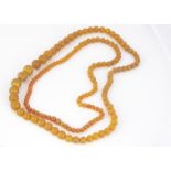 Two strings copal amber beads, both circular and graduated, 35 cm & 31 cm 111g