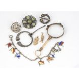 A silver Celtic Plaid brooch, with Glasgow hallmarks for 1950, a Viking brooch, two gold charms in