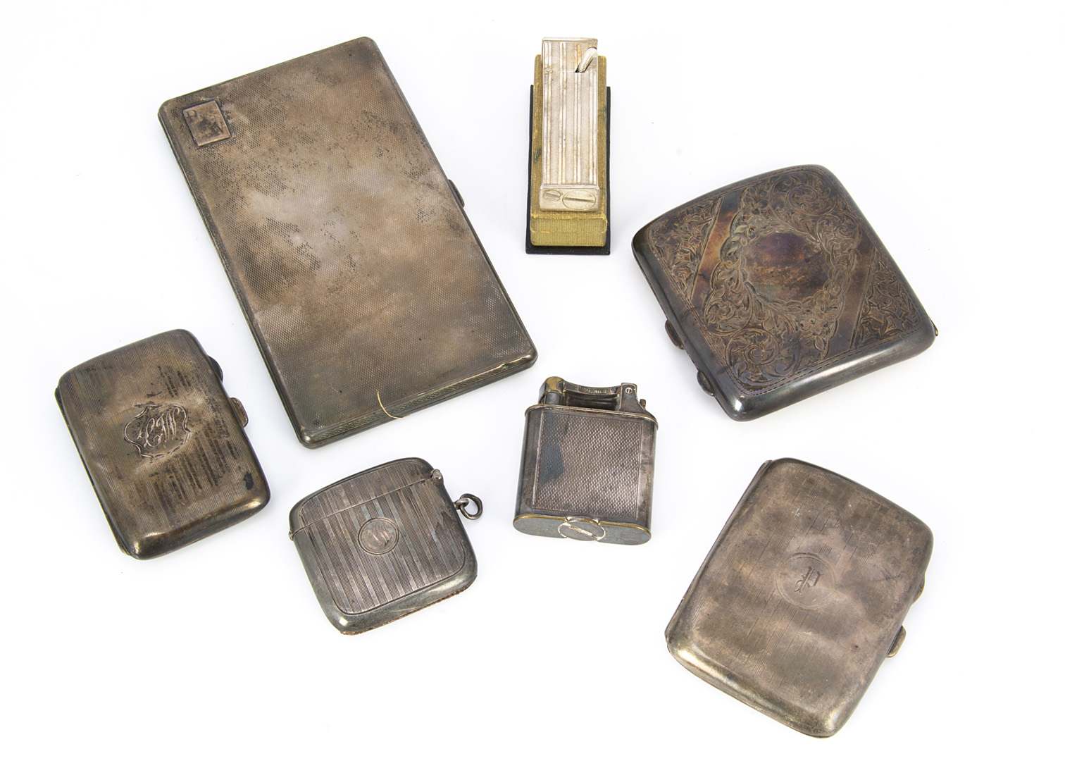 Four Victorian and Art Deco silver cigarette cases and a vesta case and two cigarette lighters,