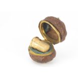 A 19th century walnut thimble case, AF, containing gilt thimble in fitted interior, cracked and
