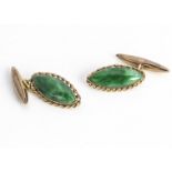 A pair of continental jadeite jade and yellow metal cufflinks, navette shape with crimped rim, 2.2cm
