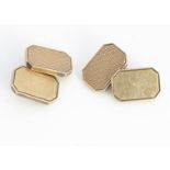 A pair of 9ct gold rectangular fronted cufflinks, with canted corners, one engine turned, united