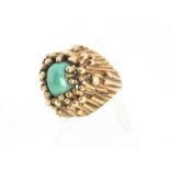 A yellow metal and turquoise dress ring, the cabochon stone in a linear mount and claw setting, ring